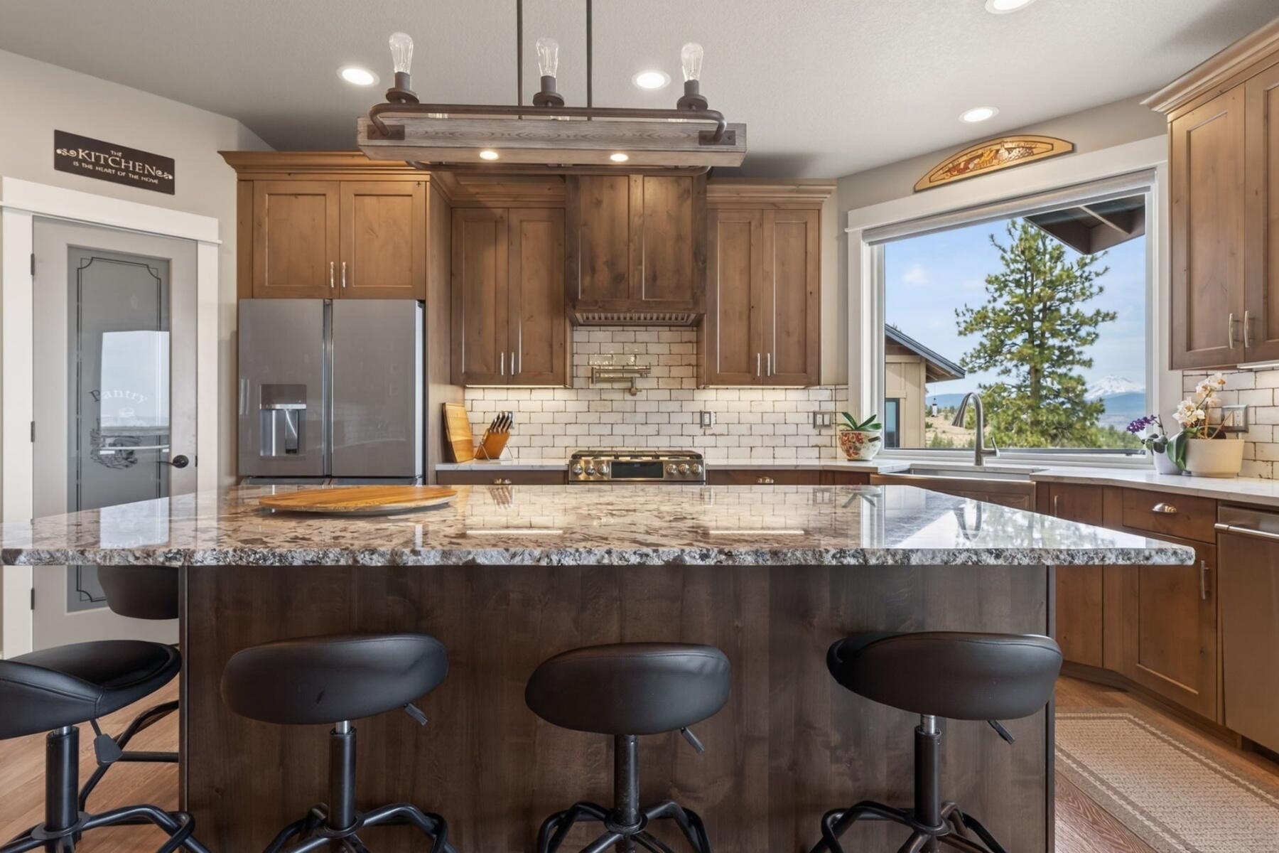 11620 Southwest Pixie Lane Culver, OR 97734 - Photo 14 of 53 a large kitchen with granite countertop a counter space chairs and cabinets