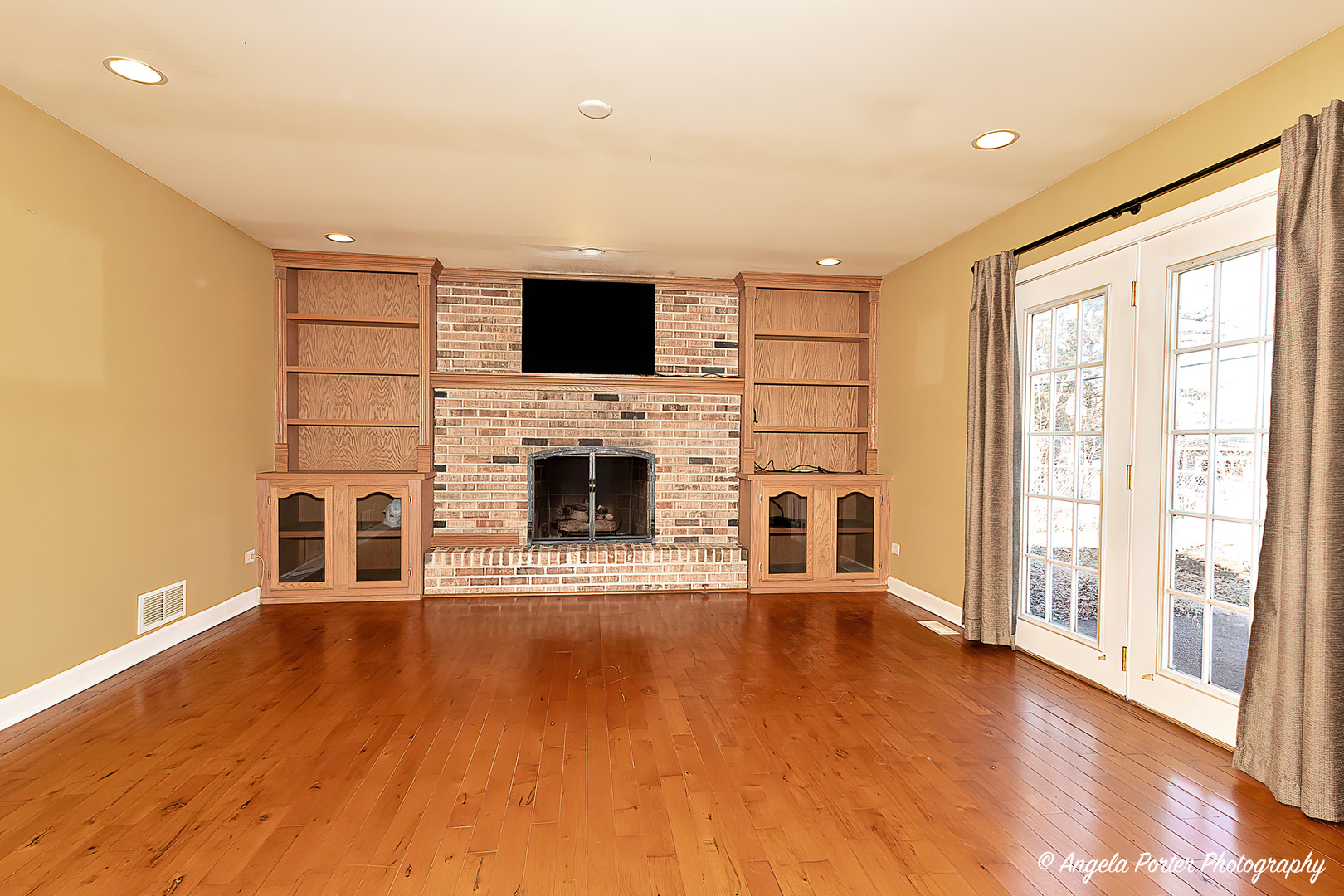 110 Bay Road McHenry, IL 60051 - Photo 12 of 28 a living room with a flat screen tv and a fireplace