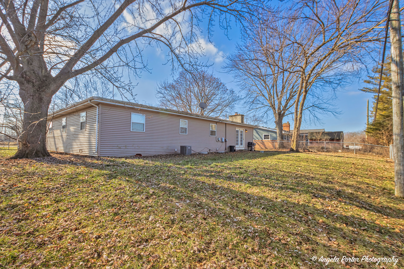 110 Bay Road McHenry, IL 60051 - Photo 24 of 28 a backyard of a house with large trees and outdoor seating
