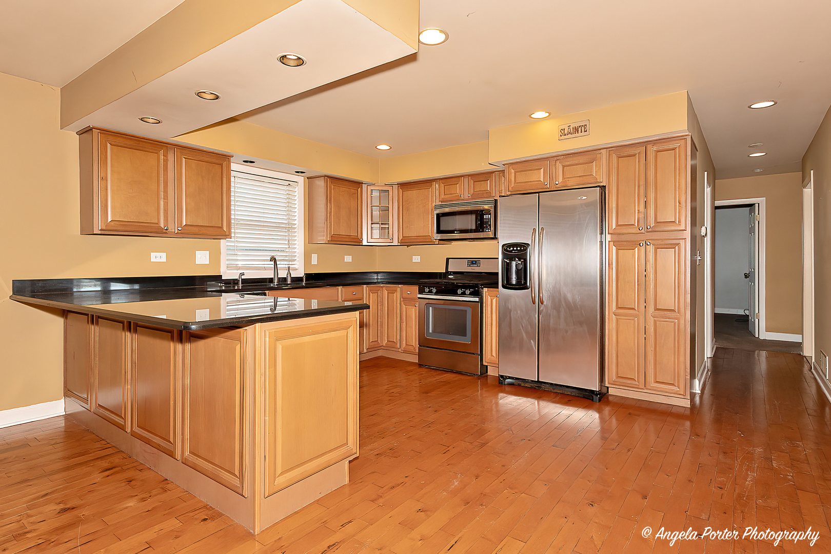 110 Bay Road McHenry, IL 60051 - Photo 4 of 28 a kitchen with stainless steel appliances granite countertop a refrigerator a sink a stove and oven with wooden floor