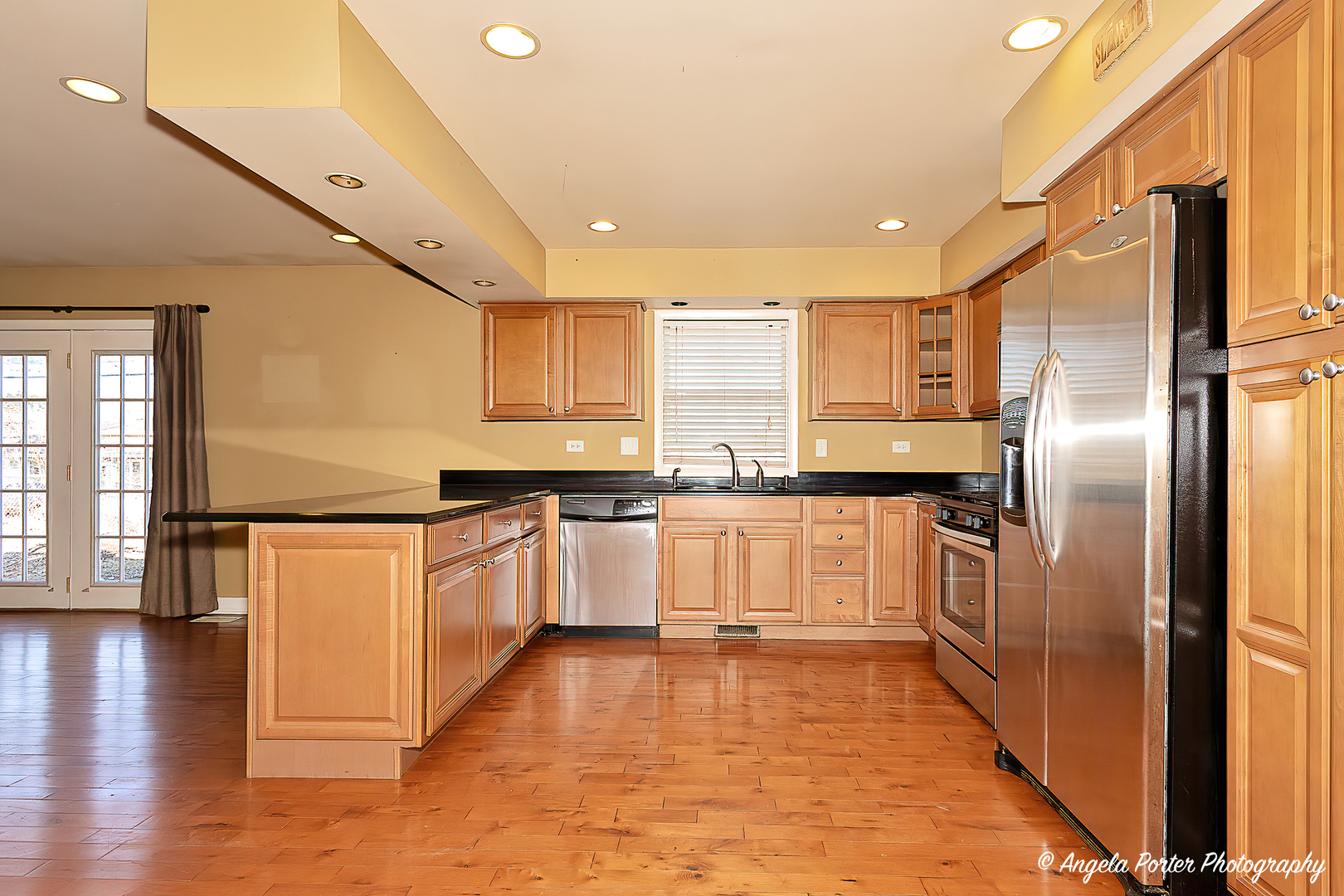 110 Bay Road McHenry, IL 60051 - Photo 7 of 28 a large kitchen with a large counter top a sink stainless steel appliances and cabinets