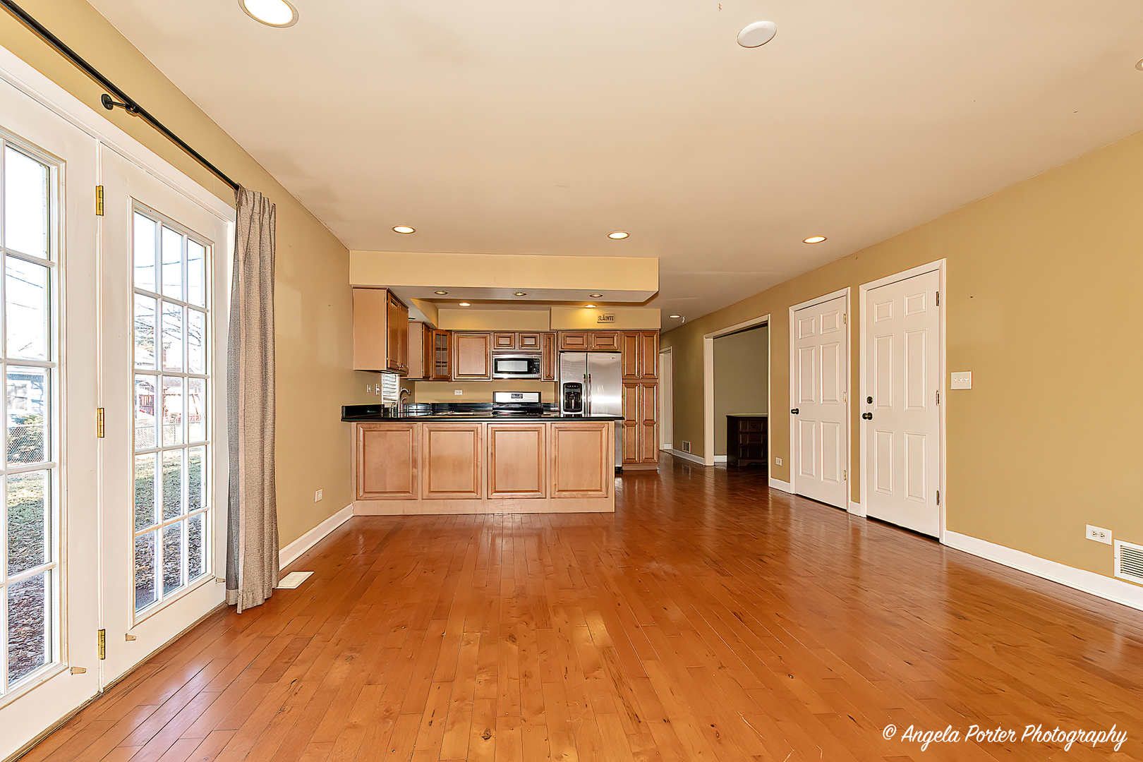 110 Bay Road McHenry, IL 60051 - Photo 9 of 28 a view of open kitchen with kitchen island a sink wooden floor and a refrigerator