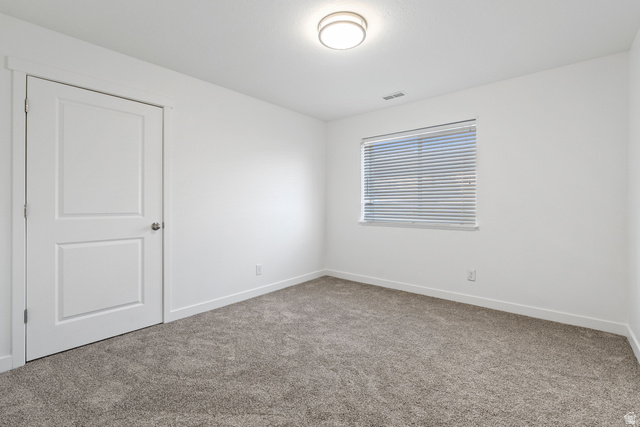8204 North Cedar Springs Road, Unit 2 Eagle Mountain, UT 84005 - Photo 12 of 17 Spare room featuring carpet flooring and baseboards