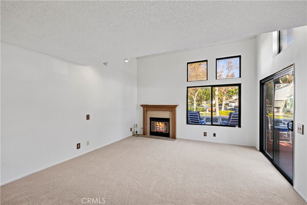 123 Fallingstar Irvine, CA 92614 - Photo 11 of 25 a view of an empty room with a window and a fireplace