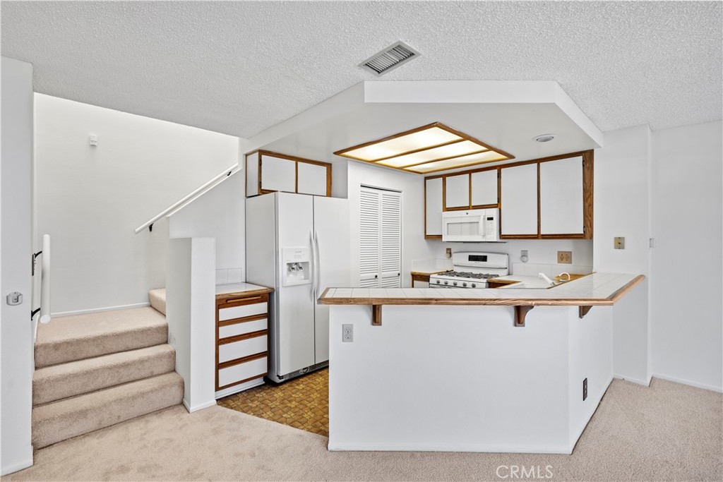 123 Fallingstar Irvine, CA 92614 - Photo 14 of 25 a kitchen with stainless steel appliances a stove and more cabinets