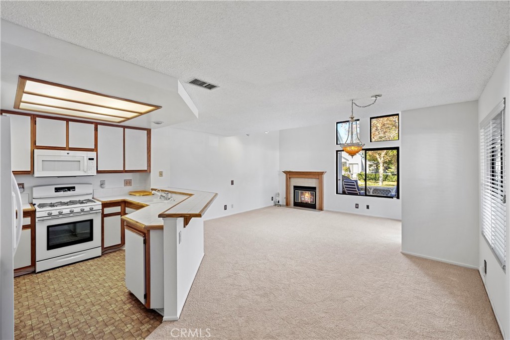 123 Fallingstar Irvine, CA 92614 - Photo 15 of 25 a kitchen with a stove and a microwave