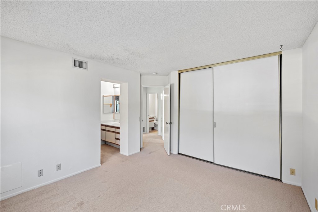 123 Fallingstar Irvine, CA 92614 - Photo 21 of 25 a view of an empty room with a cabinet and mirrors