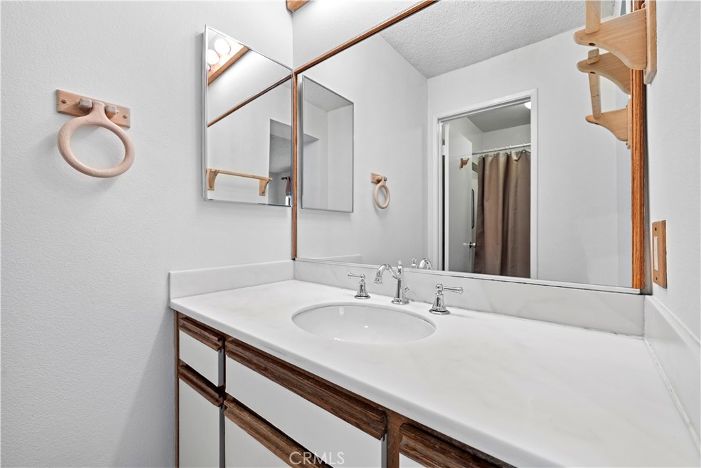 123 Fallingstar Irvine, CA 92614 - Photo 22 of 25 a bathroom with a sink vanity and a mirror