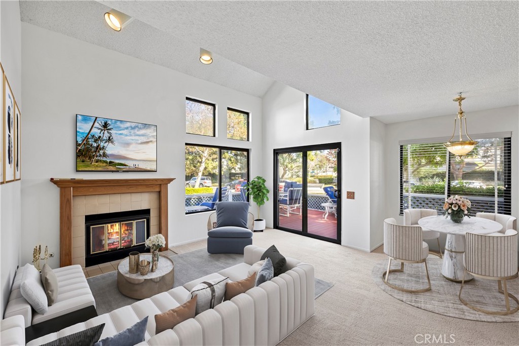 123 Fallingstar Irvine, CA 92614 - Photo 9 of 25 a living room with furniture a fireplace and a floor to ceiling window