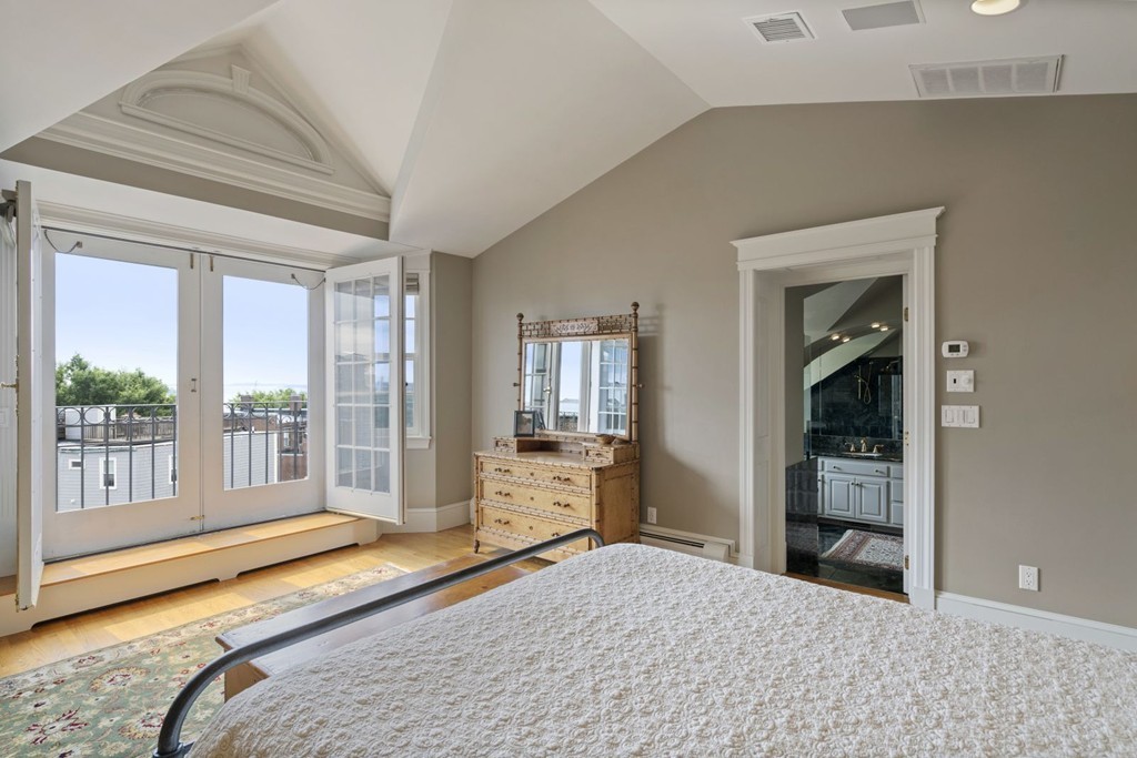 6 Monument Square, Unit 4 Boston, MA 02129 - Photo 20 of 37 a bedroom with a bed and large windows