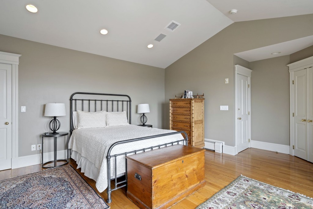 6 Monument Square, Unit 4 Boston, MA 02129 - Photo 21 of 37 a bedroom with a bed and wooden floor