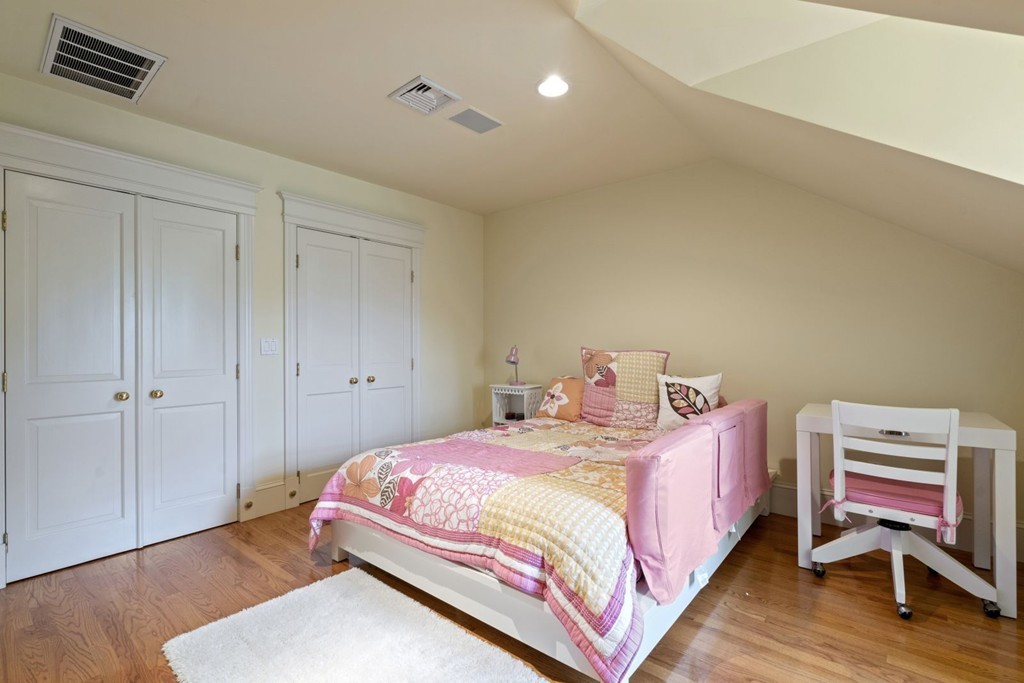 6 Monument Square, Unit 4 Boston, MA 02129 - Photo 24 of 37 a bedroom with a bed and wooden floor