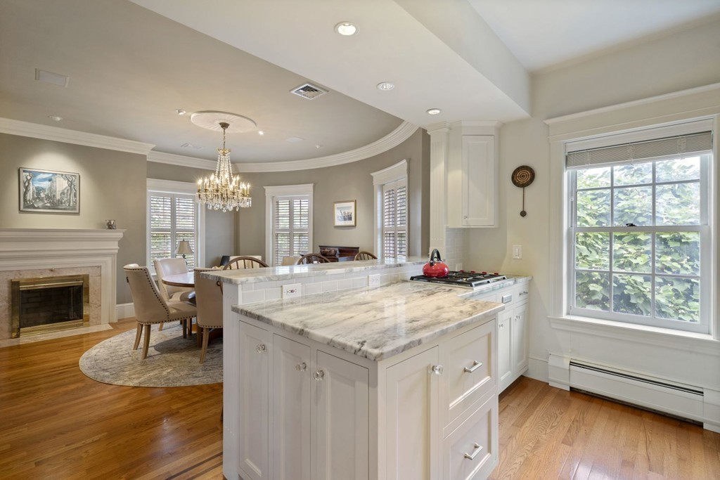 6 Monument Square, Unit 4 Boston, MA 02129 - Photo 4 of 37 a living room with kitchen island granite countertop furniture a fireplace and a large window