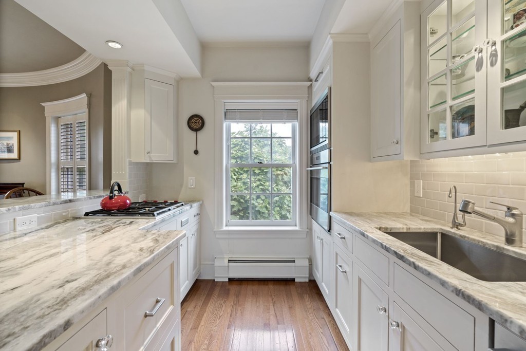 6 Monument Square, Unit 4 Boston, MA 02129 - Photo 5 of 37 a bathroom with a granite countertop sink a large mirror and a bathtub