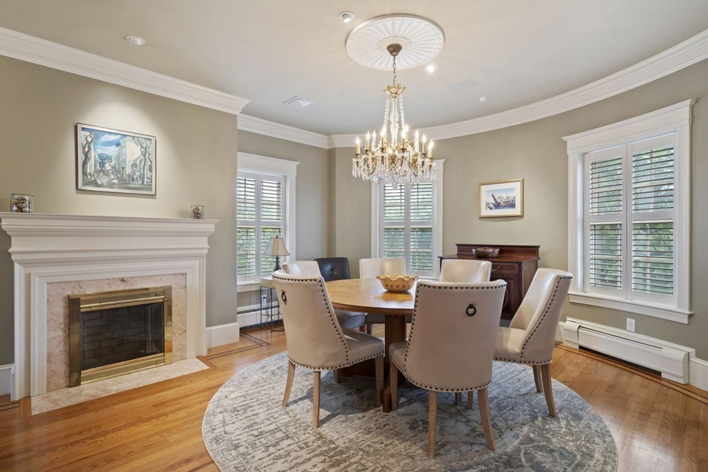 6 Monument Square, Unit 4 Boston, MA 02129 - Photo 8 of 37 a view of a dining room with furniture a chandelier and wooden floor