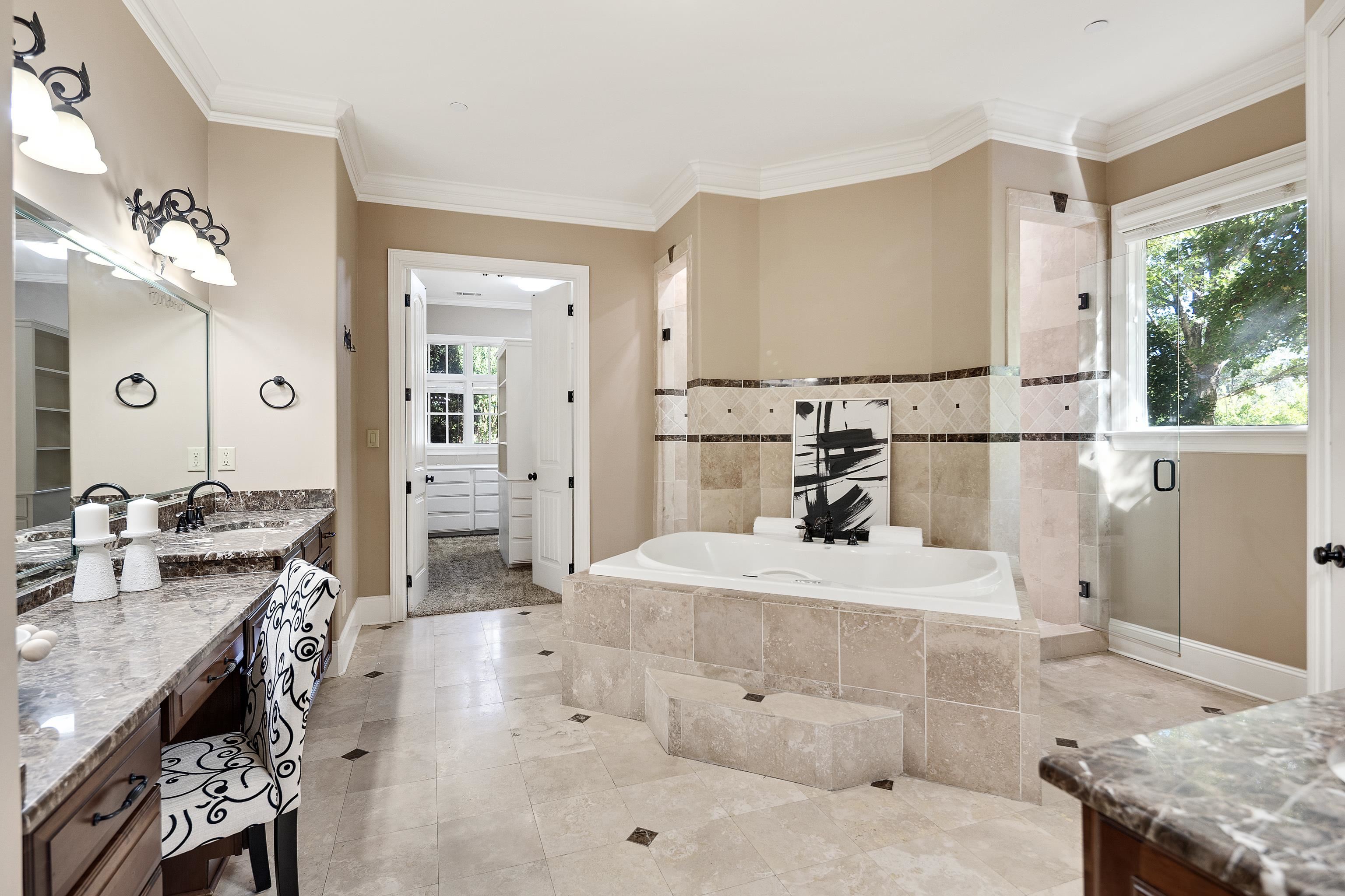 425 Buckland Cove Eads, TN 38028 - Photo 17 of 29 Bathroom featuring vanity, a garden tub, a shower stall, crown molding, and light tile patterned floors
