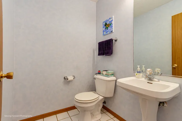 a bathroom with a sink mirror and toilet