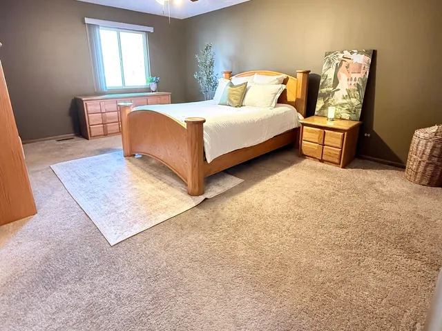 a bedroom with a bed and a table
