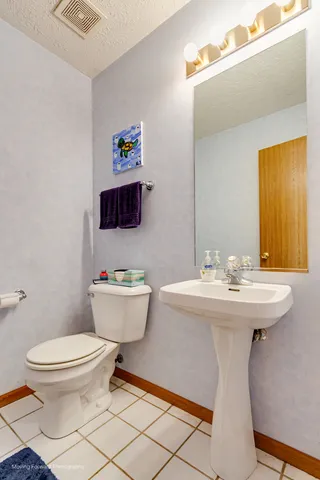 a bathroom with a sink mirror and toilet