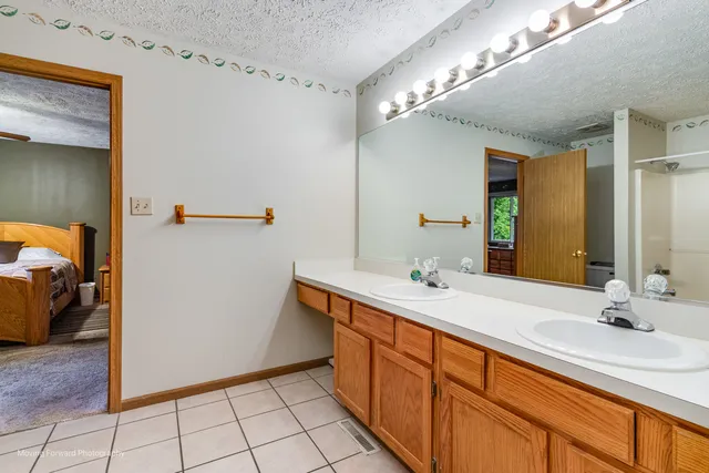 a bathroom with a double vanity sink and a mirror