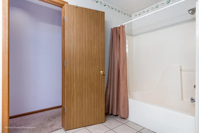 a bathroom with a shower and a tub