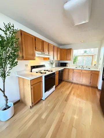 a kitchen with a sink stove and cabinets
