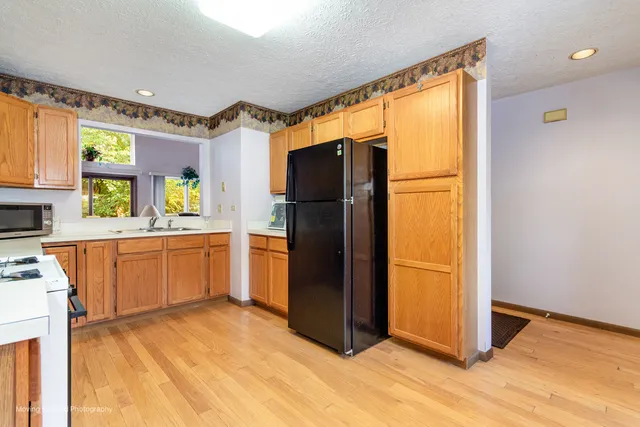 a kitchen with stainless steel appliances granite countertop a refrigerator and a sink