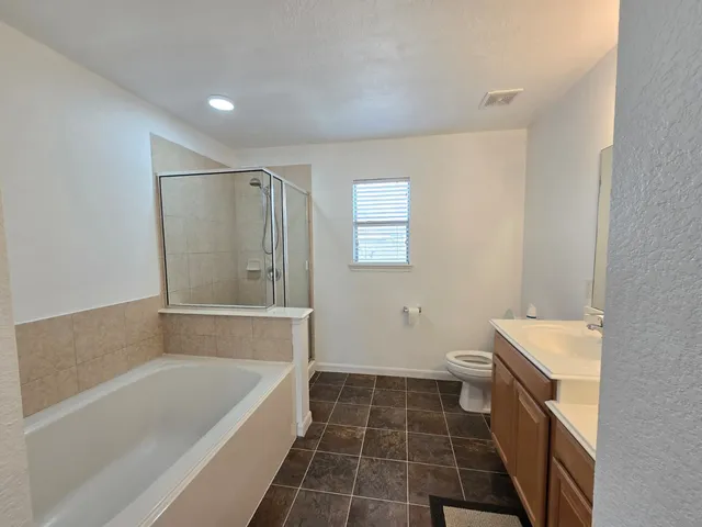a spacious bathroom with a bathtub sink and toilet