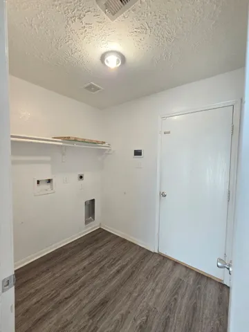 a view of a room with wooden floor