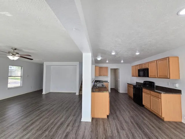 a view of kitchen with sink and wooden floor