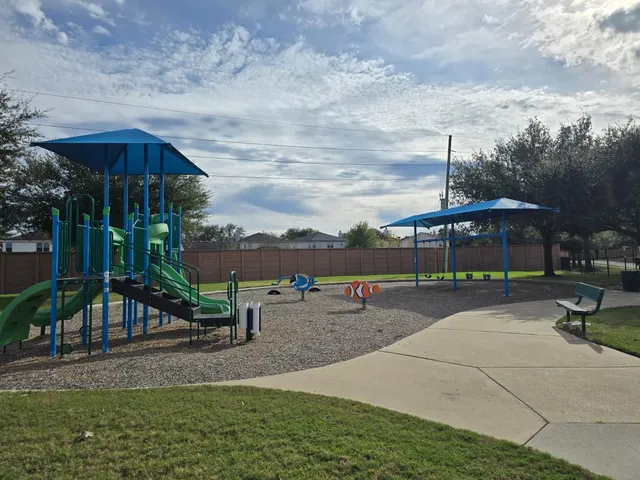 a view of swimming pool with a yard and large tree