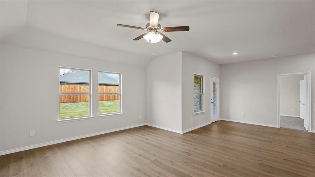 111 Lantern Road Caddo Mills, TX 75135 - Photo 15 of 40 a view of an empty room with wooden floor and a window