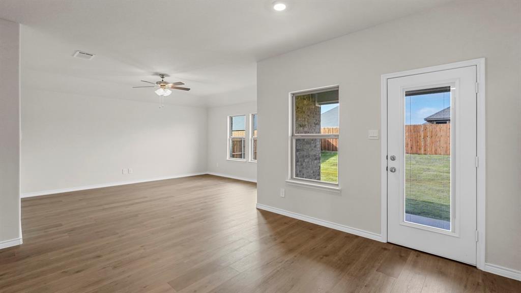 111 Lantern Road Caddo Mills, TX 75135 - Photo 19 of 40 a view of an empty room with a window and wooden floor