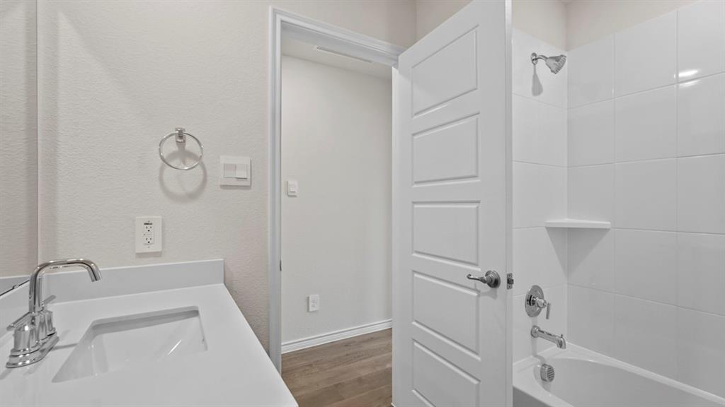 111 Lantern Road Caddo Mills, TX 75135 - Photo 29 of 40 a bathroom with a sink a toilet and shower