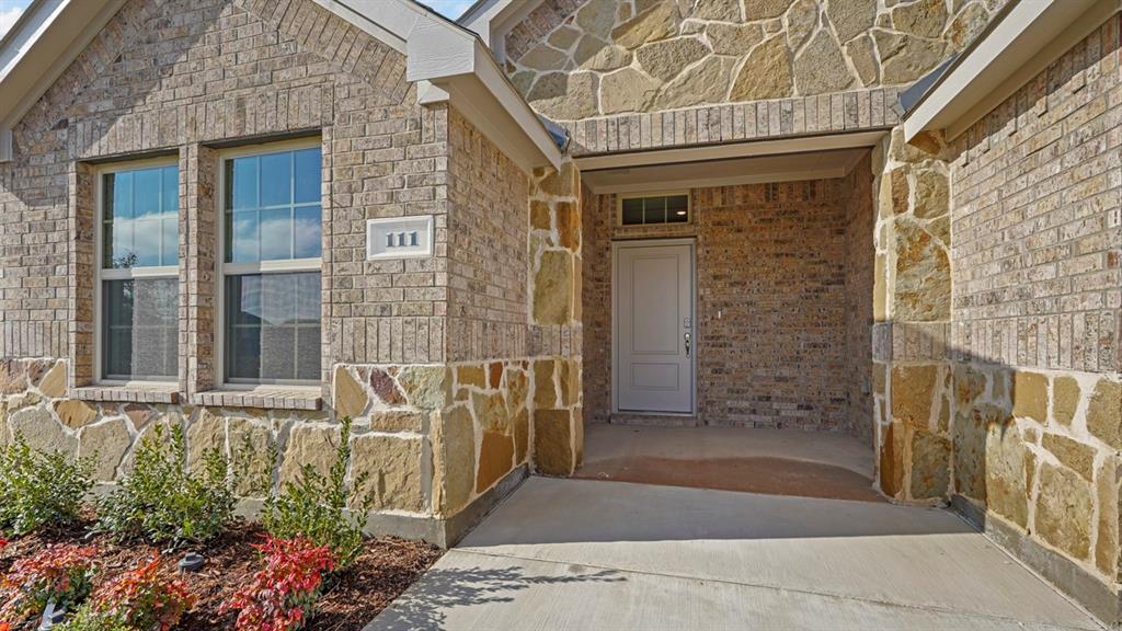 111 Lantern Road Caddo Mills, TX 75135 - Photo 4 of 40 a front view of a house with a glass door