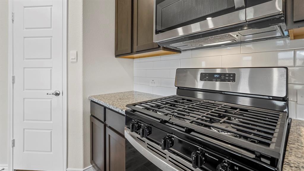 111 Lantern Road Caddo Mills, TX 75135 - Photo 9 of 40 a stove top oven sitting inside of a kitchen