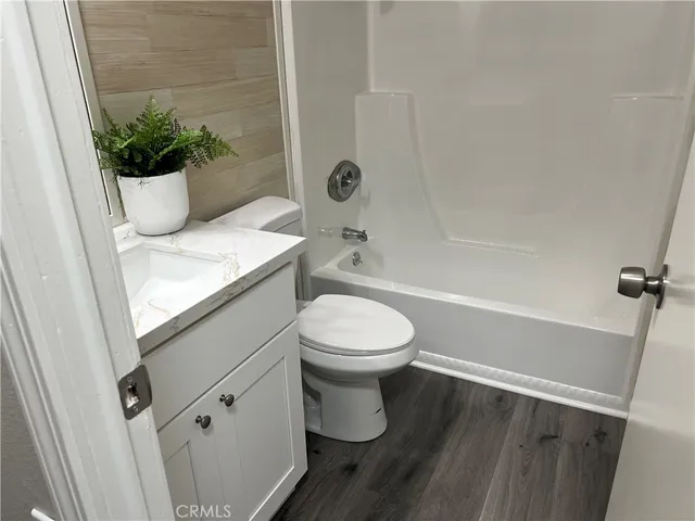 a bathroom with a toilet a sink and shower