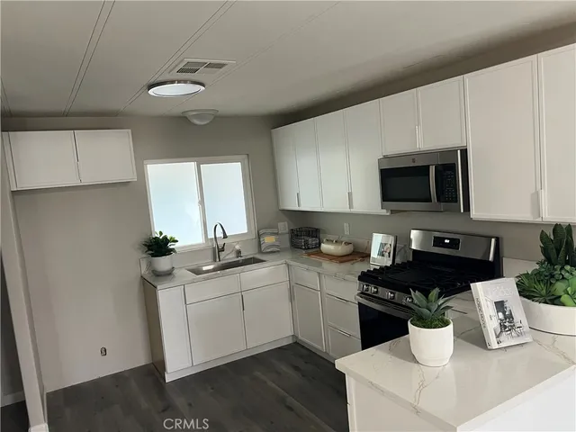 a kitchen with a sink and white appliances