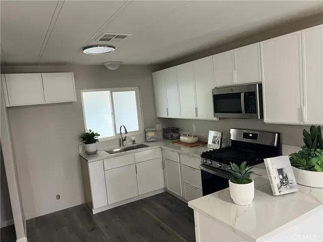 a kitchen with a sink and white appliances