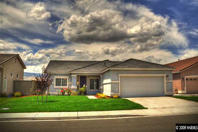 1717 Canyon Shadow Circle Reno, NV 89521 - Photo 1 of 5 a front view of a house with a garden and trees
