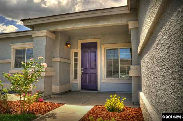 1717 Canyon Shadow Circle Reno, NV 89521 - Photo 2 of 5 a front view of a house with a garden