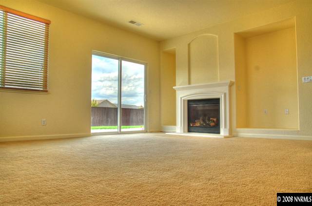 1717 Canyon Shadow Circle Reno, NV 89521 - Photo 4 of 5 a view of an empty room with a fireplace and a window