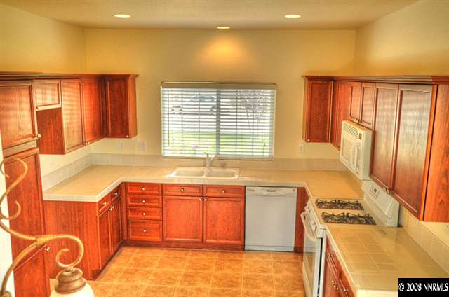 1717 Canyon Shadow Circle Reno, NV 89521 - Photo 5 of 5 a kitchen with stainless steel appliances granite countertop a sink and a stove