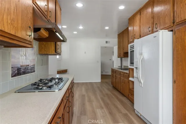 a kitchen with a refrigerator and a stove