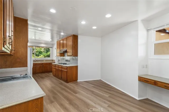a kitchen with a refrigerator stove and sink