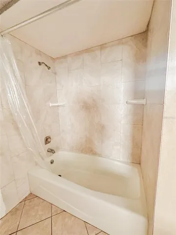 a bathroom with a shower and a bath tub