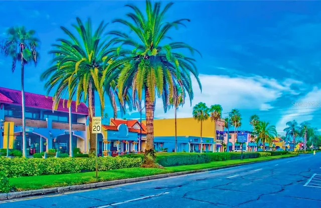 a view of a multi story residential apartment building with a yard and entertaining space