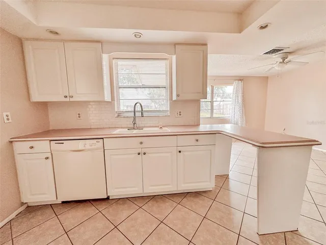 a kitchen with a sink cabinets and window