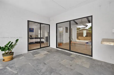 a view of an empty room and a potted plant