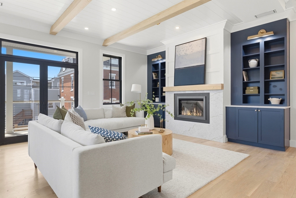 847 East 5th Street, Unit 2 Boston, MA 02127 - Photo 11 of 24 a living room with furniture and a fireplace
